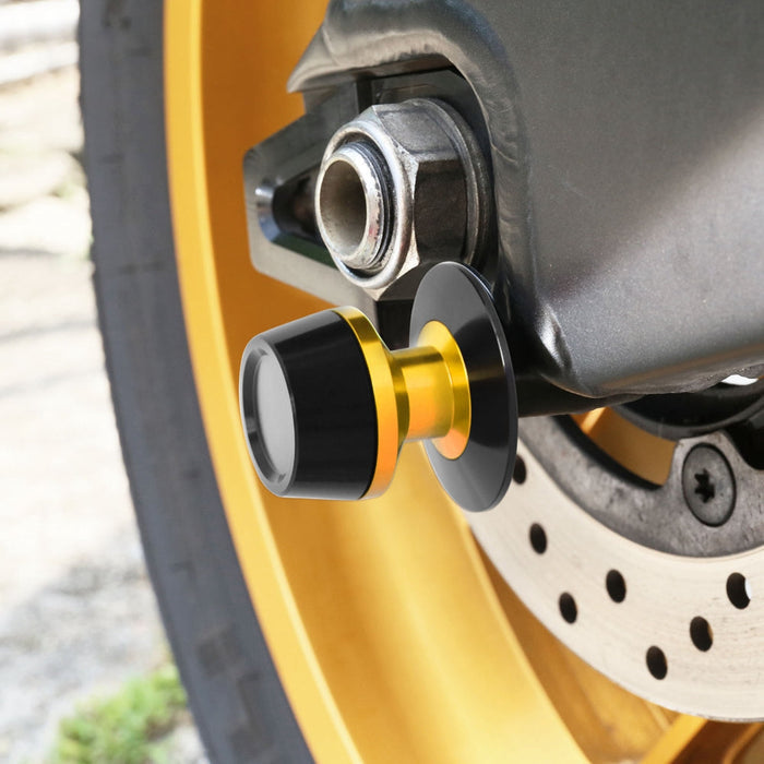 Customized engraved MC Motoparts laser text swingarm spools in 6mm, 8mm, and 10mm sizes installed on motorcycle swingarm.