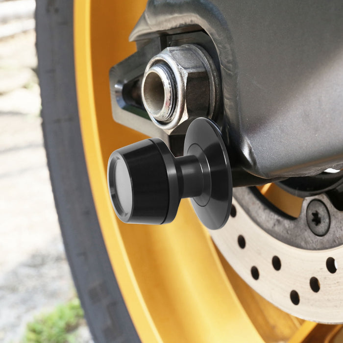 Black MC Motoparts S-Fight 8mm swingarm spools installed on a BMW S1000R motorcycle for easy rear wheel removal.