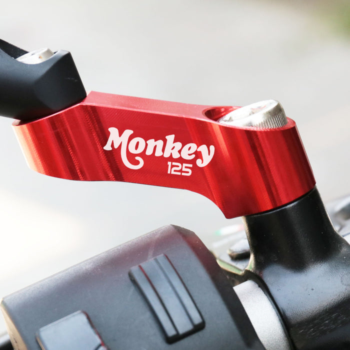 Honda Monkey 125 mirror extender riser by MC Motoparts, showing the side mirror extension installed on the motorcycle.