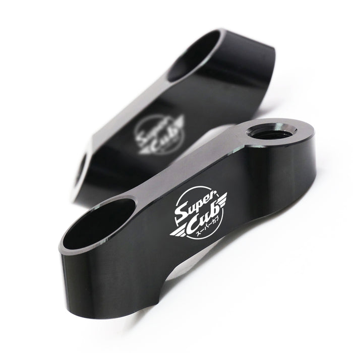 Black Honda Super Cub C125 mirror extender riser by MC Motoparts, showing engraved logo and adjustable side mirror extension.
