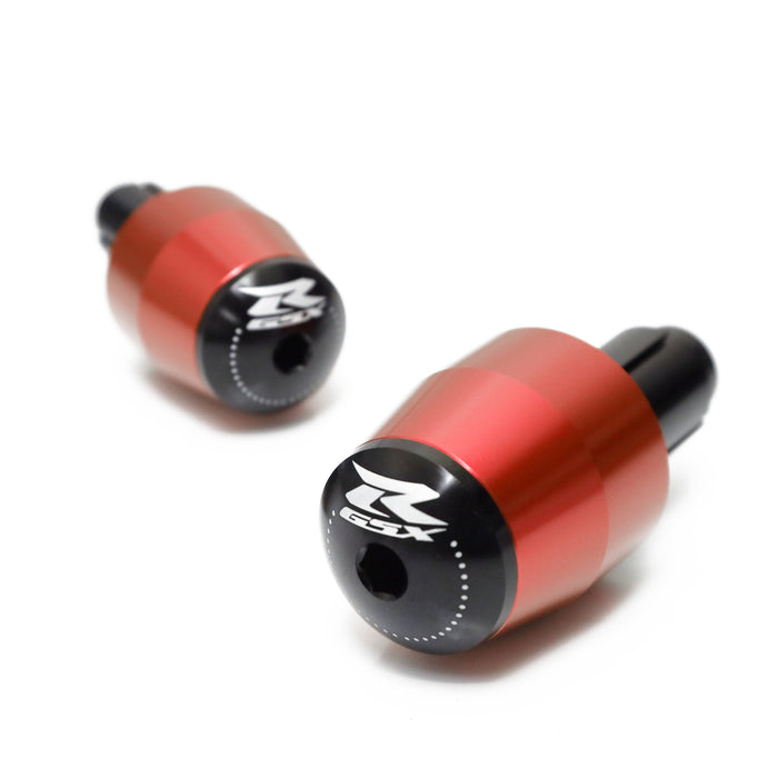 Red engraved logo MC Motoparts handlebar ends for Suzuki GSXR motorcycle, with metal construction and logo detail.