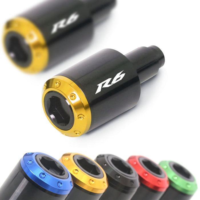 Engraved logo MC Motoparts Atom bar ends for Yamaha YZF R6 2006-2024, black and gold finish, mounted on motorcycle handlebars.