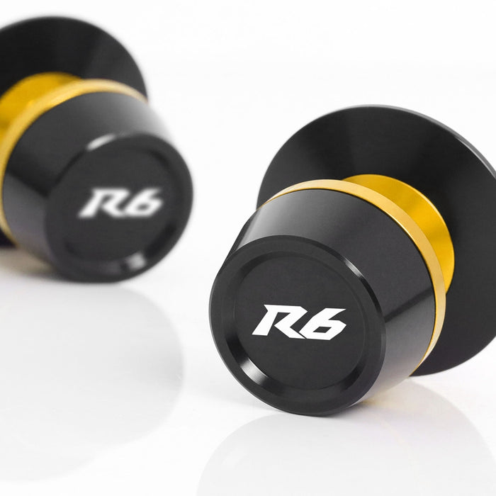 MC Motoparts Yamaha YZF R6 R6S swingarm spools with engraved logo, 6mm diameter for easy motorcycle wheel removal.