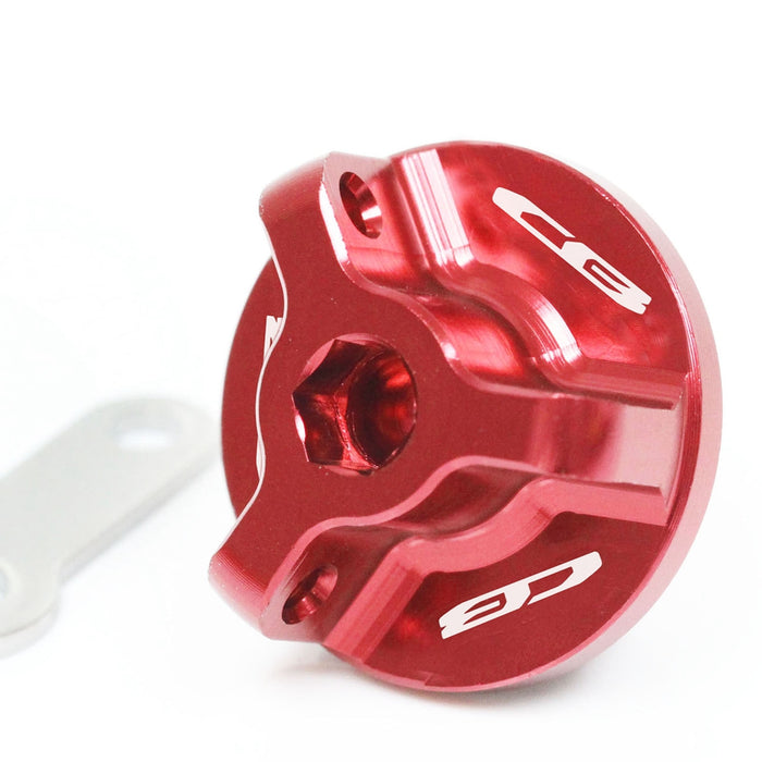 Red engraved oil filler cap with Honda CB1000R, CB500X, CB500F, and CB600F logo by MC Motoparts on a motorcycle engine.