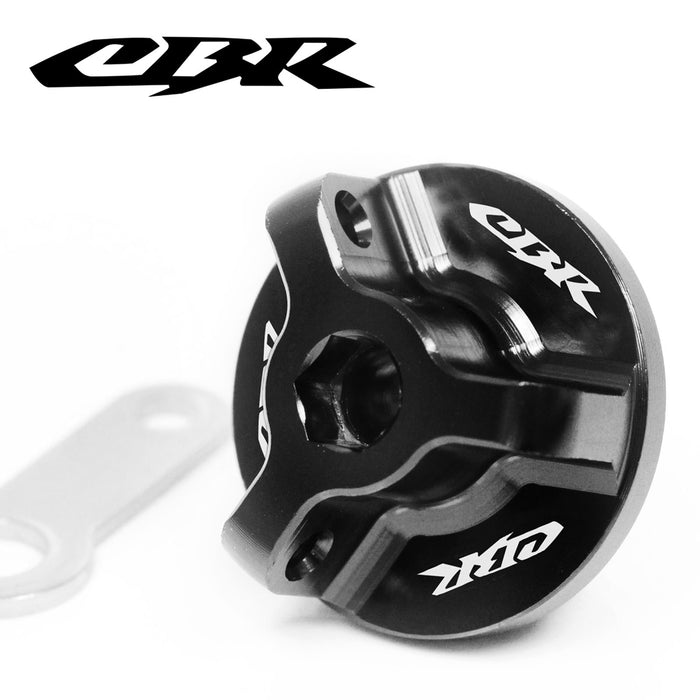 Black engraved Honda CBR oil filler cap by MC Motoparts with logo detail, designed for CBR929RR, CBR954RR, and CBR600F motorcycle models.
