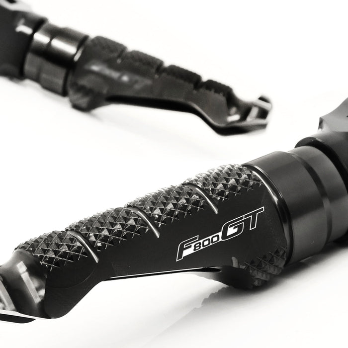 BMW F800GT 2011-2018 R-FIGHT engraved logo standard foot pegs by MC Motoparts, shown on motorcycle's footrest area.