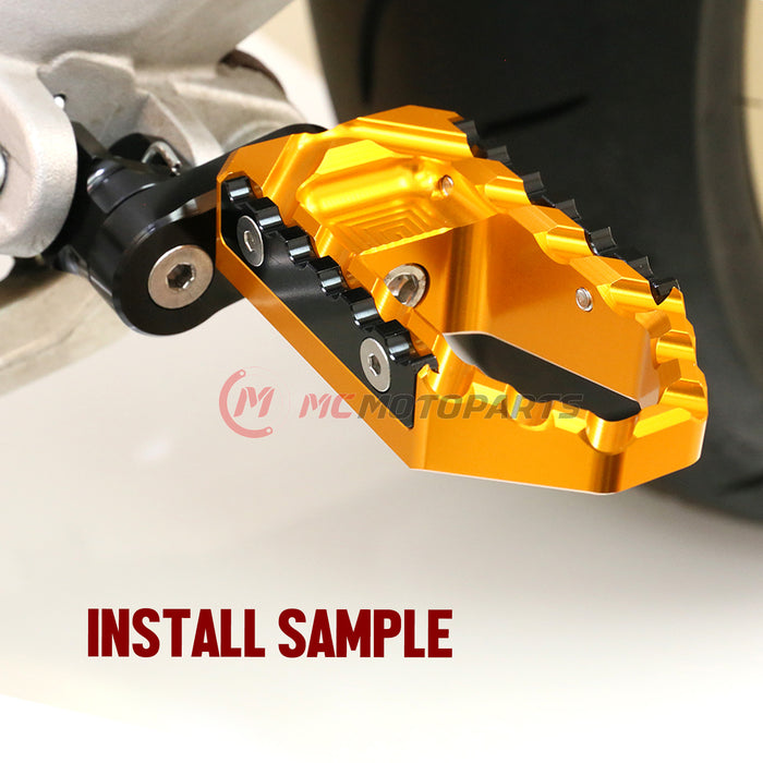 Black 25mm extension foot pegs for BMW R nineT and K1300R, designed for touring, by MC Motoparts, with installation image.