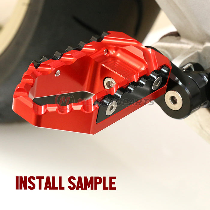 Honda CBR600RR and CBR1000RR touring 25mm wide extension foot pegs by MC Motoparts, shown installed on motorcycle.