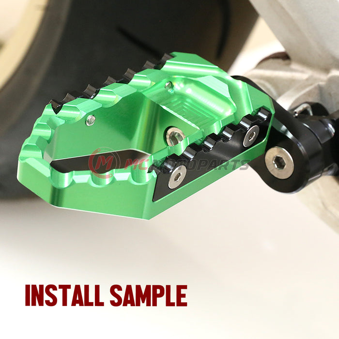 MC Motoparts 25mm extension foot pegs for Kawasaki ZX10R and ZX6R, front view showing black multi-step touring foot pegs installed.