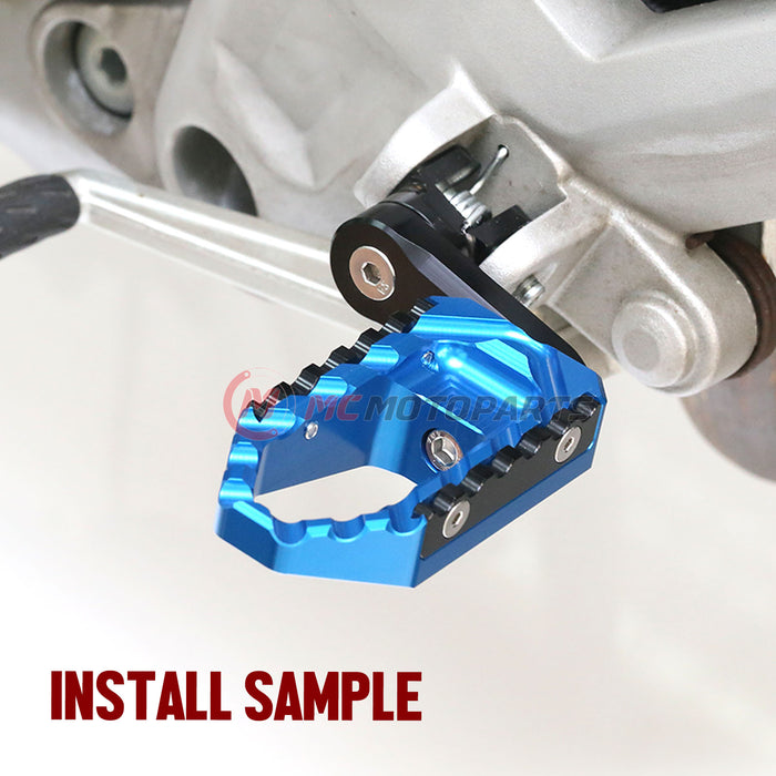 MC Motoparts 40mm extension foot pegs for Moto Guzzi V9, V7, V100 touring models, adjustable wide foot pegs installed on motorcycle.