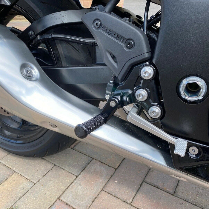 Black 40mm extension foot pegs for Suzuki GSX-R 600, 750, 1000 by MC Motoparts, shown installed on a 2022 GSX1300R motorcycle.