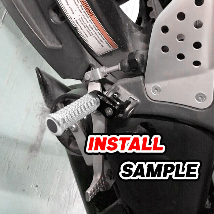Front view of MC Motoparts 25mm extension foot pegs for Triumph Scrambler 1200 and Trident 660 motorcycle, installed on foot pegs.
