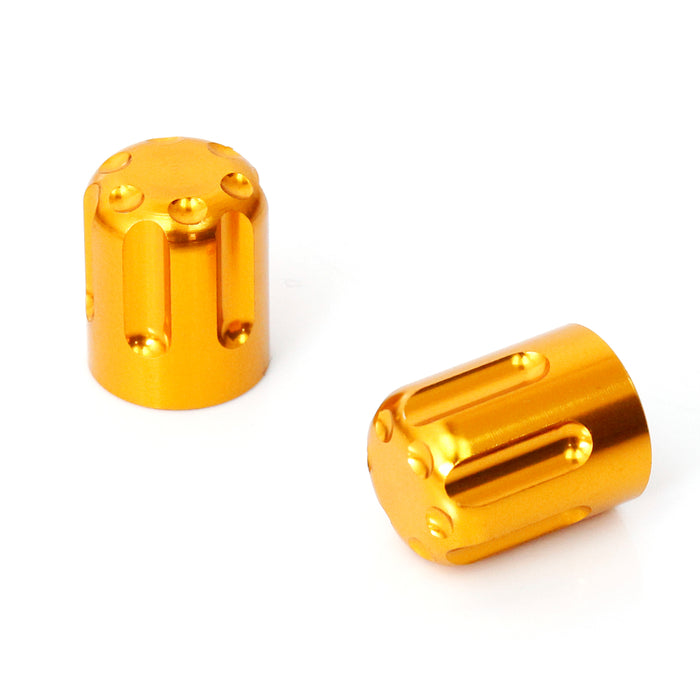 Gold motorcycle tire valve stem caps by MC Motoparts, showing a close-up of the durable valve caps on a wheel.