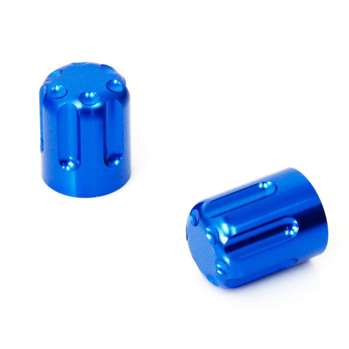 Blue motorcycle tire valve stem caps by MC Motoparts, close-up of durable metal valve caps on a motorcycle wheel.