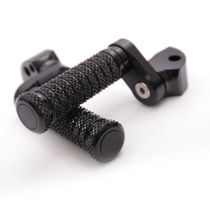 Rear 25mm extension foot pegs for Aprilia RSV1000 Tuono V4R by MC Motoparts, black metal with mounting brackets.