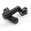 Rear 25mm extension foot pegs for Aprilia RSV1000 Tuono V4R by MC Motoparts, black metal with mounting brackets.