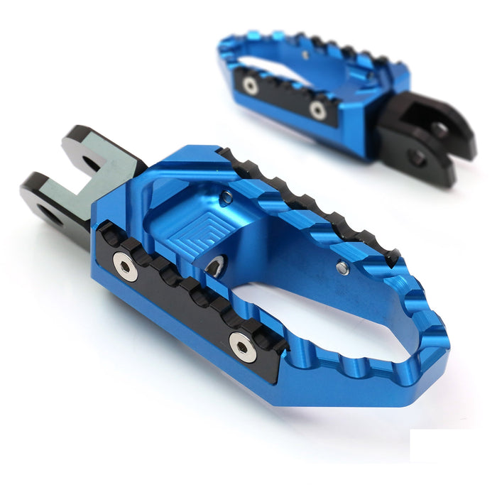 Rear MC Motoparts touring wide foot pegs for Aprilia RSV1000 Tuono V4R TRC motorcycle, standard foot pegs in black with mounting hardware.